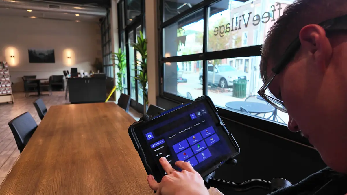 A user interacting with Ability Foundry AAC software